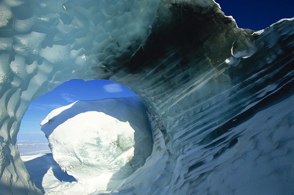 Glacial meltwater tunnel in iceberg showing sculpted water flow patterns, Spitsbergen, Svalbard, Arctic, Norway, Scandinavia, Europe