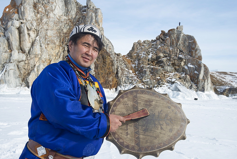 Hereditary Buryat shaman, Valentin Khagdaev with skin covered drum at Olkhon Island celebrating the spirit of Baikal on the ice, Lake Baikal, Irkutsk Oblast, Siberia, Russia, Eurasia