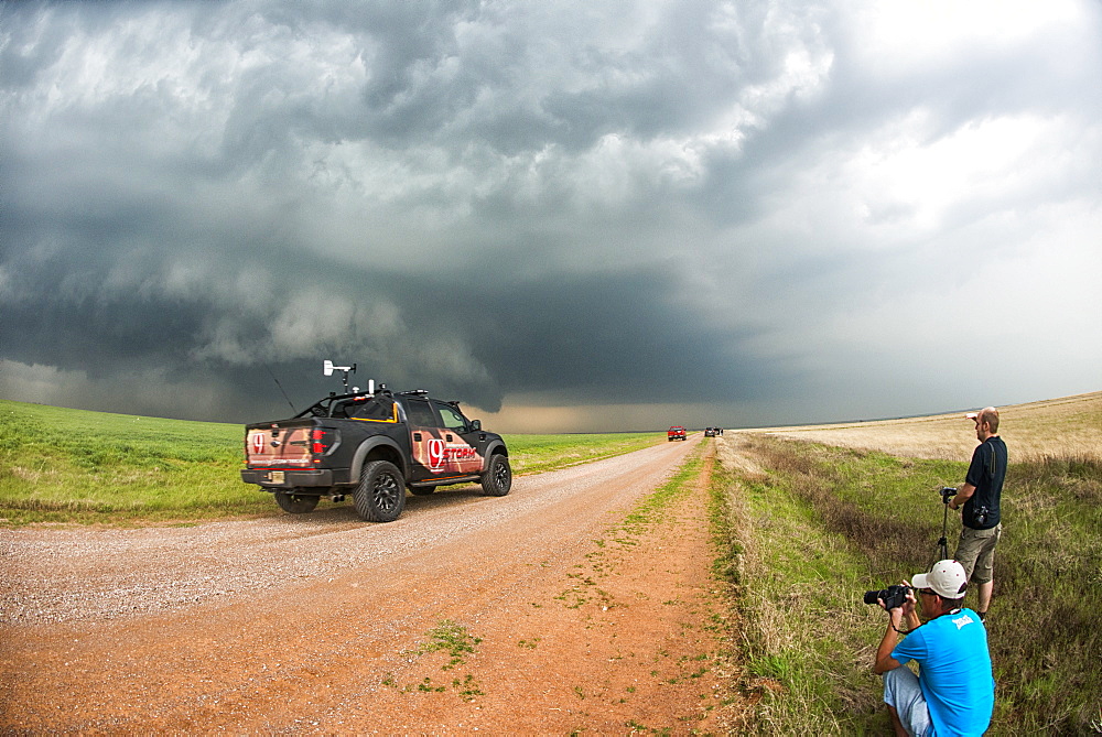 Stormchasers and TV channel nine reporting truck at scene of supercell thunderstorm near Sterling, Oklahoma, United States of America, North America