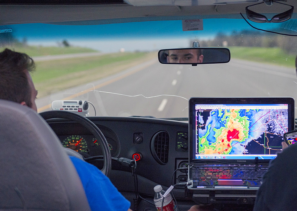 Dave Holder eyes the radar screen on the laptop of his navigator Blake Knapp, Extreme Tornado Tours, Oklahoma, United States of America, North America