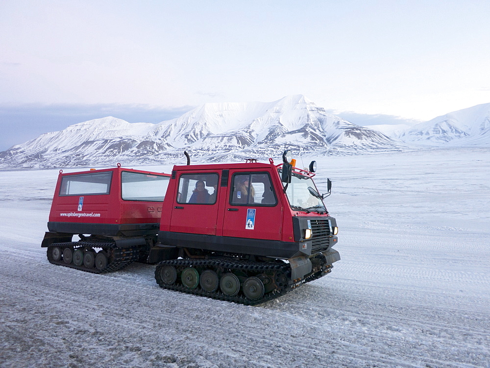 A snowcat ten wheeler tracked vehicle is used so that visitors and tourists can view landscapes protected from the winter cold, Svalbard, Arctic, Norway, Scandinavia, Europe