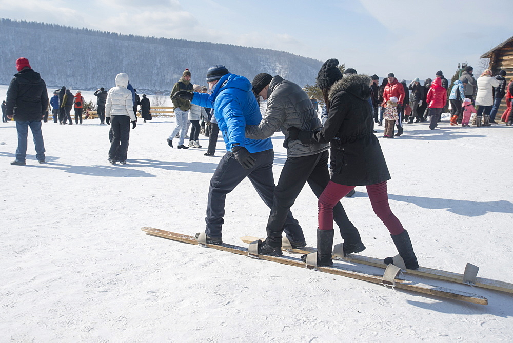 Siberians celebrate the festival of Maslenitsa with outdoor games such as group skiing, Irkutsk, Siberia, Russia, Eurasia