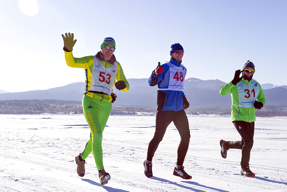 Runners in the 10th Baikal Ice Marathon, run on the frozen surface of the world's largest fresh water lake on 1st March 2014, Siberia, Irkutsk Oblast, Russia, Eurasia