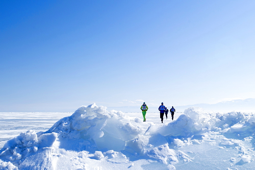 Runners in the 10th Baikal Ice Marathon, run on the frozen surface of the world's largest fresh water lake on 1st March 2014, Siberia, Irkutsk Oblast, Russia, Eurasia