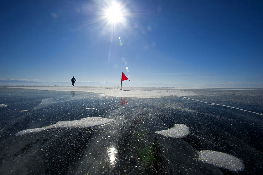 Runner in the 10th Baikal Ice Marathon, run on the frozen surface of the world's largest fresh water lake on 1st March 2014, Siberia, Irkutsk Oblast, Russia, Eurasia