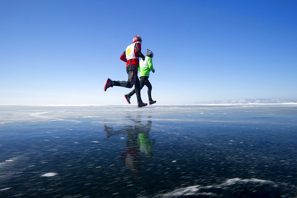 Runners in the 10th Baikal Ice Marathon, run on the frozen surface of the world's largest fresh water lake on 1st March 2014, Siberia, Irkutsk Oblast, Russia, Eurasia