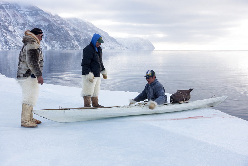 Inuit hunters use a kayak with a sealskin float to retrieve seals hunted at the floe edge, Greenland, Denmark, Polar Regions