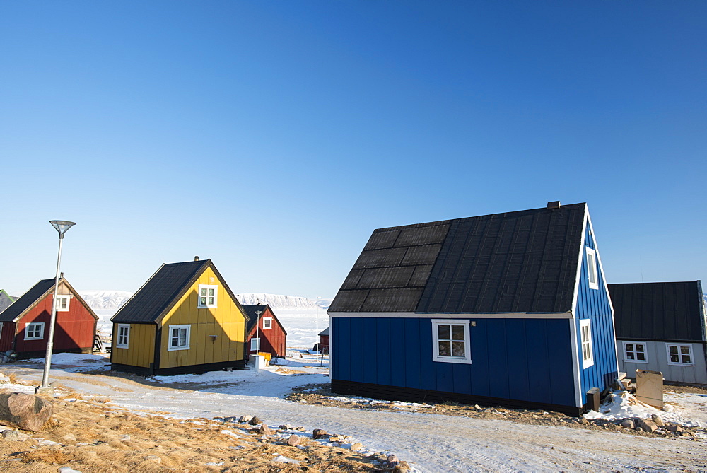 Colourful wooden houses in the village of Qaanaaq, one of the most northerly human settlements on the planet and home to 656 mostly Inuit people, Greenland, Denmark, Polar Regions