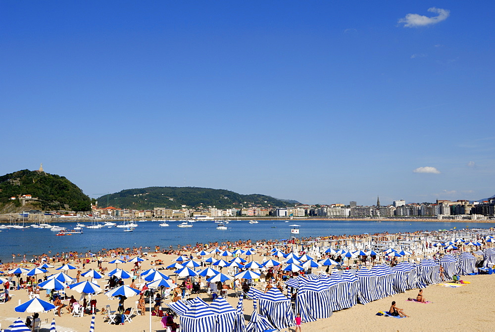 Parasols on the beach and town view, San Sebastian, Basque country, Euskadi, Spain, Europe