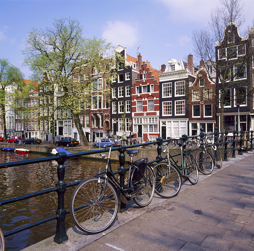 Bicycles on a bridge across the canal at Herengracht in Amsterdam, Holland 