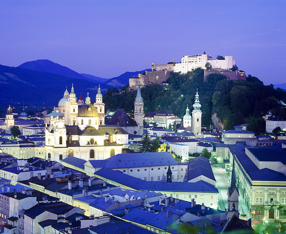 The cathedral and fortress illuminated at night in the town of Salzburg, Austria 