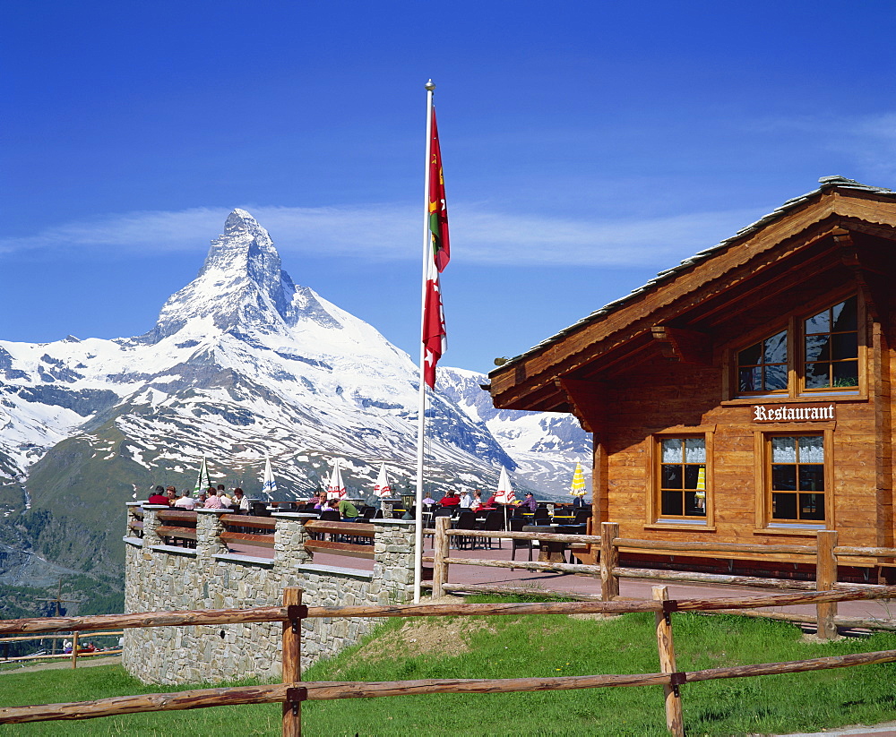 Tourists on the balcony of the restaurant at Sunnegga looking at the Matterhorn in Switzerland, Europe