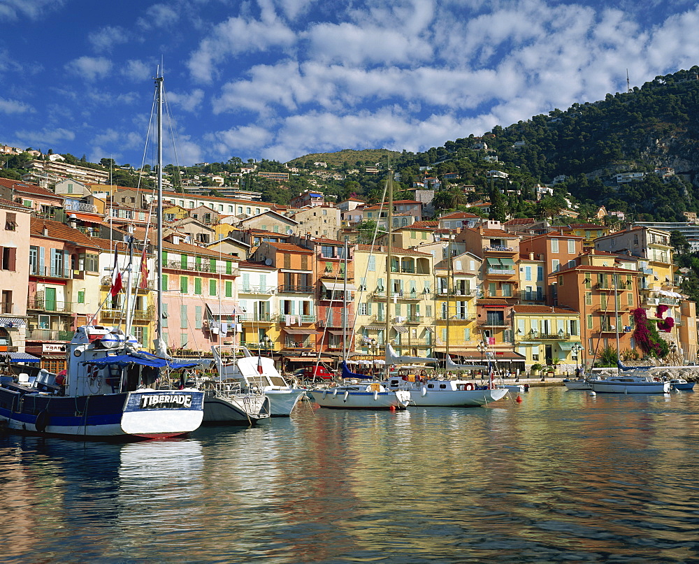 Boats in the harbour and painted houses on the waterfront in the town of Villefranche, on the Cote d'Azur, Provence, Mediterranean, France, Europe