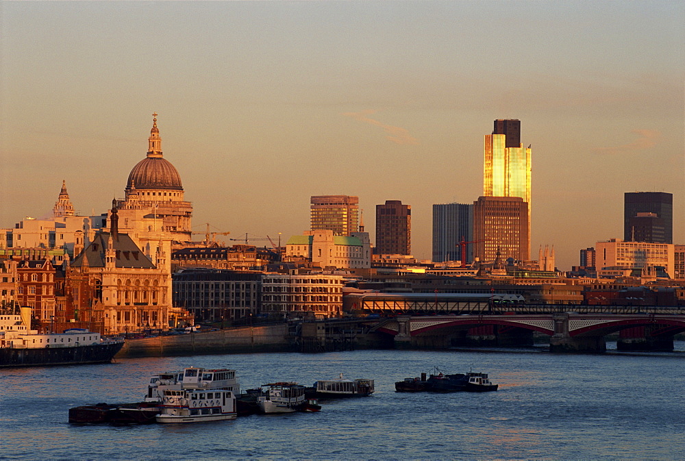 City skyline, including St. Paul's Cathedral, the NatWest Tower and Southwark Bridge, from across the Thames at dusk, London, England, United Kingdom, Europe