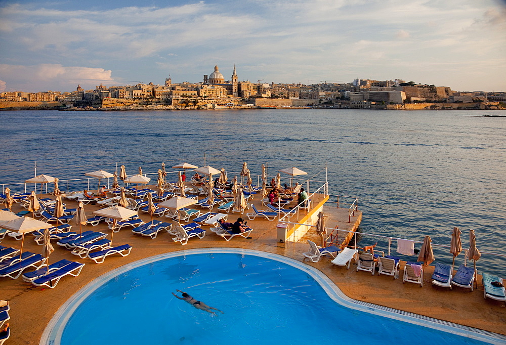 Valletta and dome of Carmelite Church from swimming pool in Sliema, Malta, Mediterranean, Europe