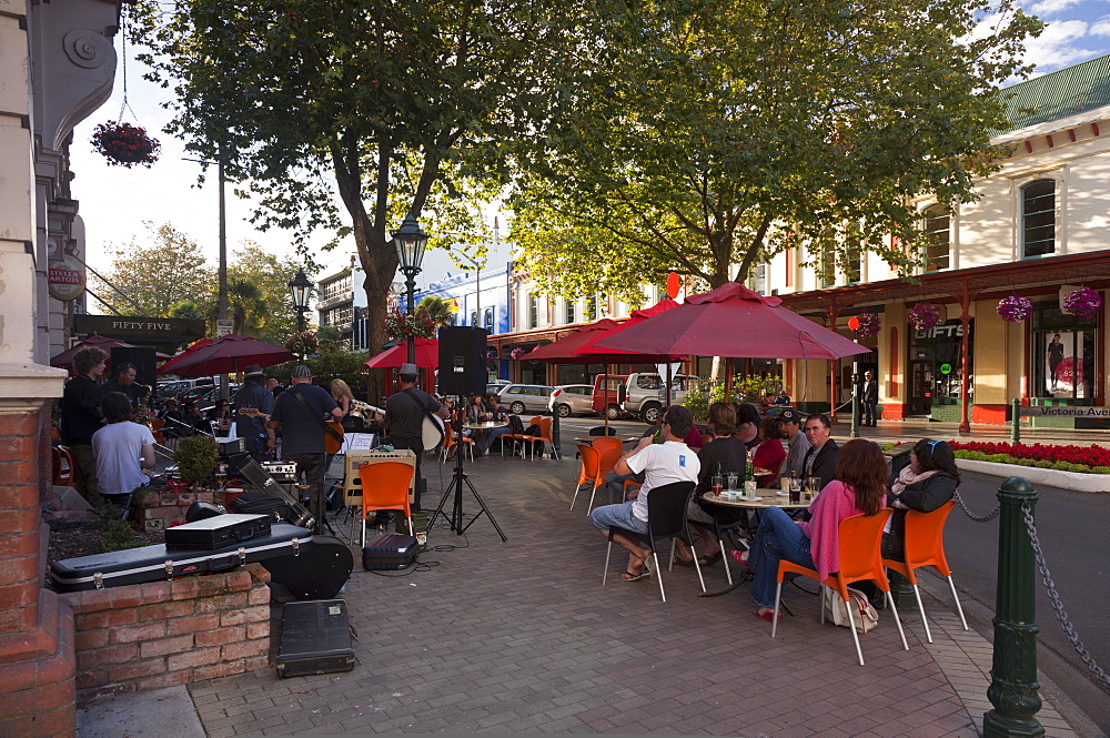 People at cafe and band playing, evening, Victoria Avenue, Whanganui, North Island, New Zealand, Pacific