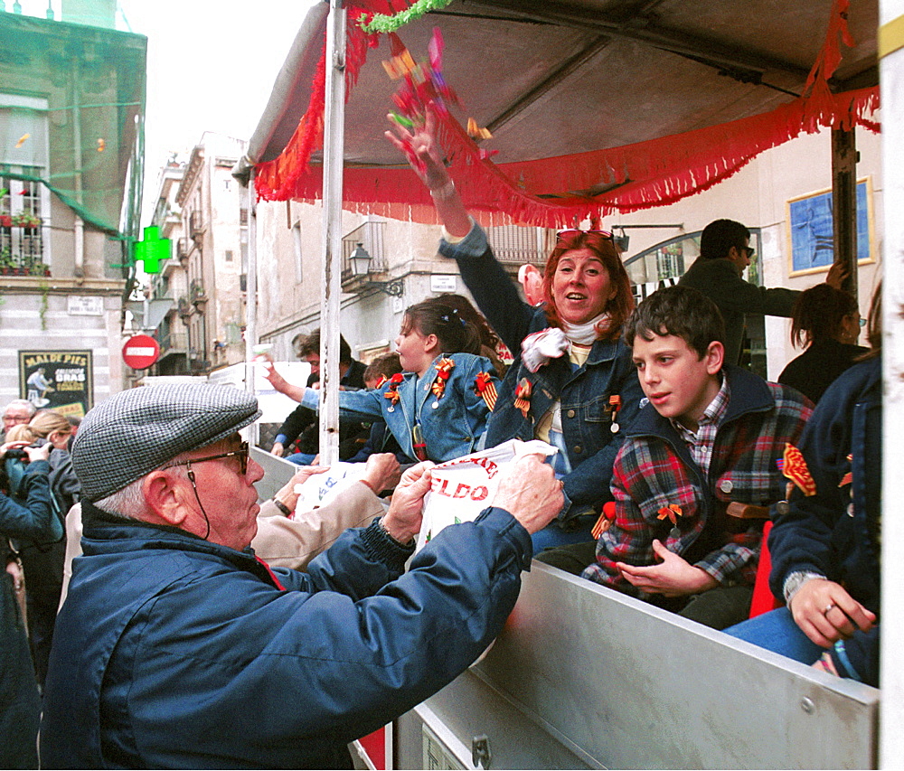 Barcelona,Spain - Fiesta Sant Medir - A pensioner moves in for the sweets thrown from the floats during the parade