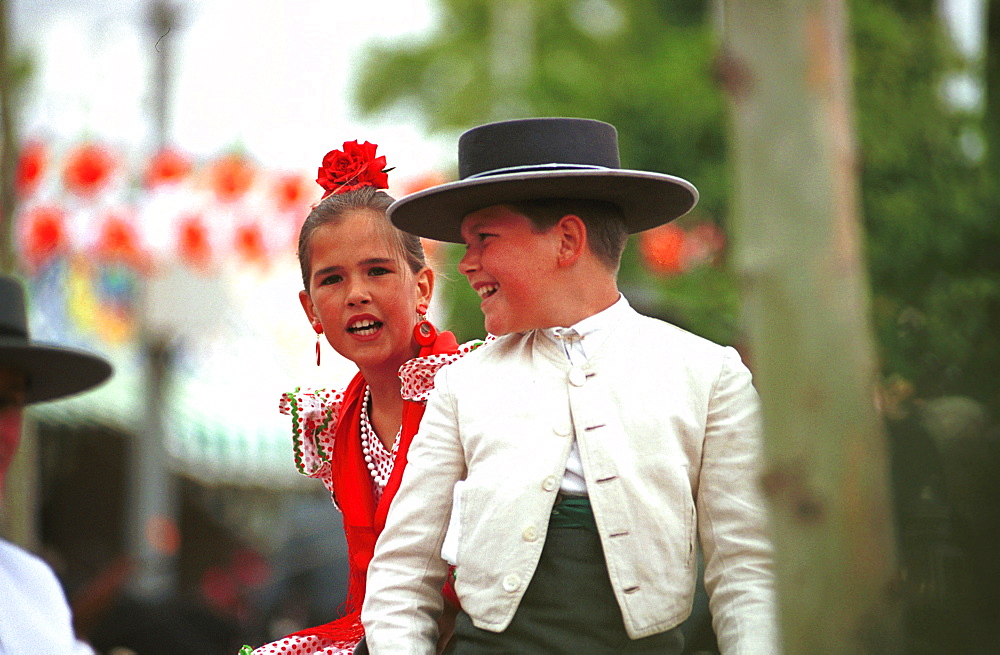 Seville - Spain - The Feria de Abril - Seville Fair - Children in traditional costume riding around the fairground 