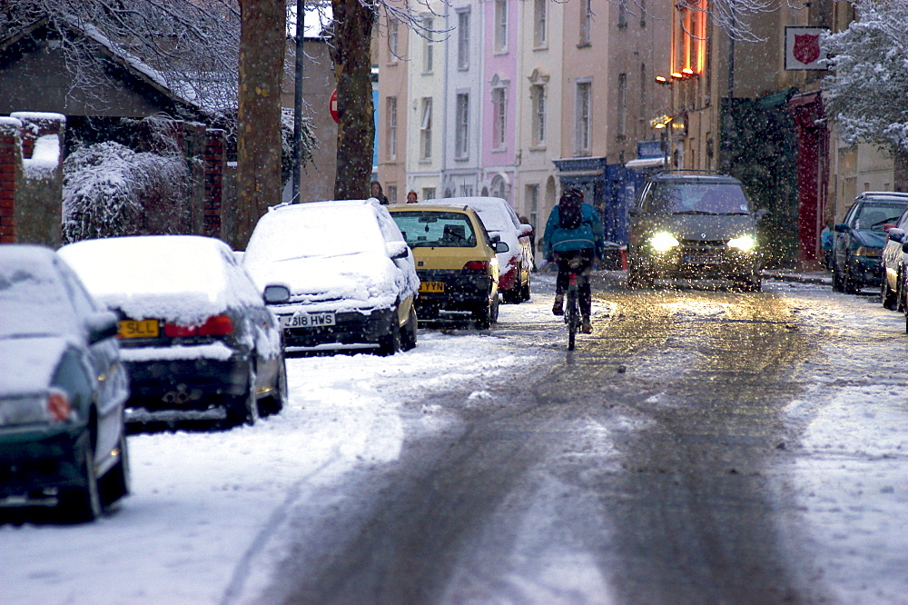 Street scene with snow on cars at dusk during winter, England, United Kingdom, Europe