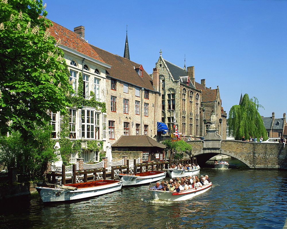 Tourist boat trip on canals of Bruges, Belgium, Europe