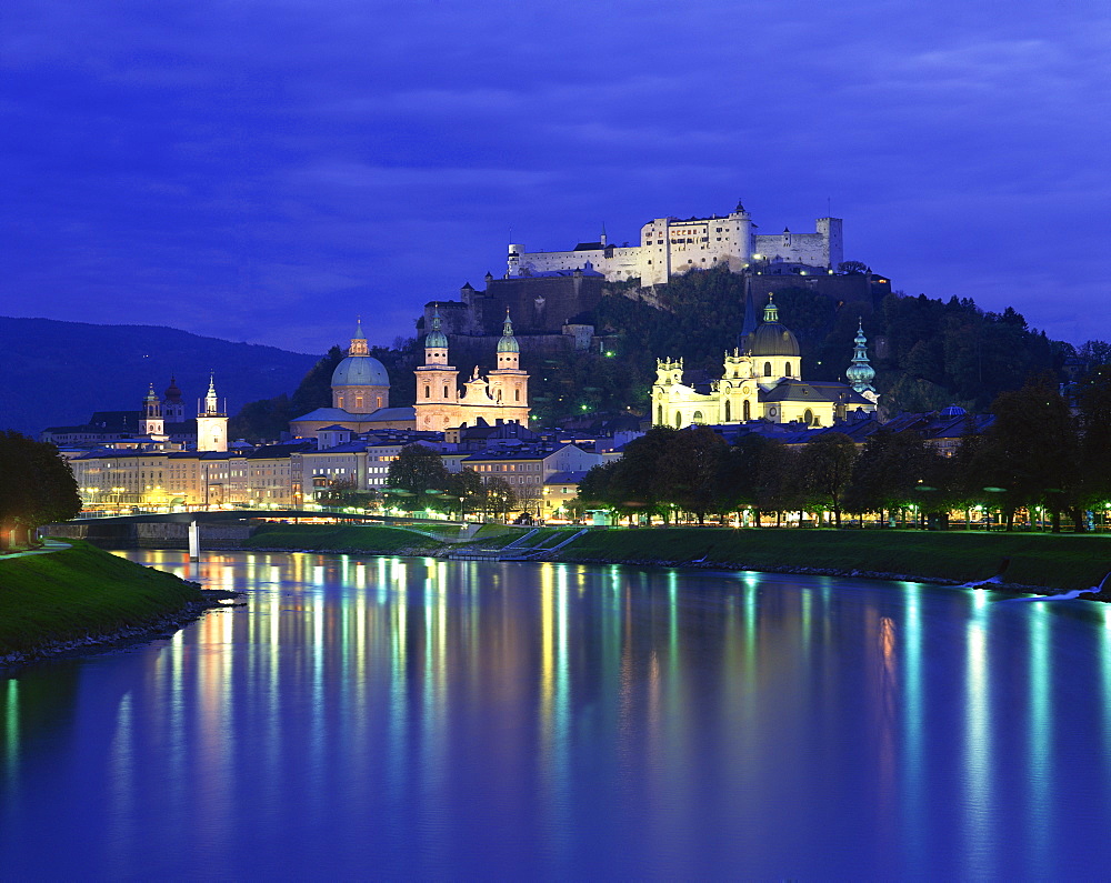 City and castle at night from the river, Salzburg, Austria, Europe