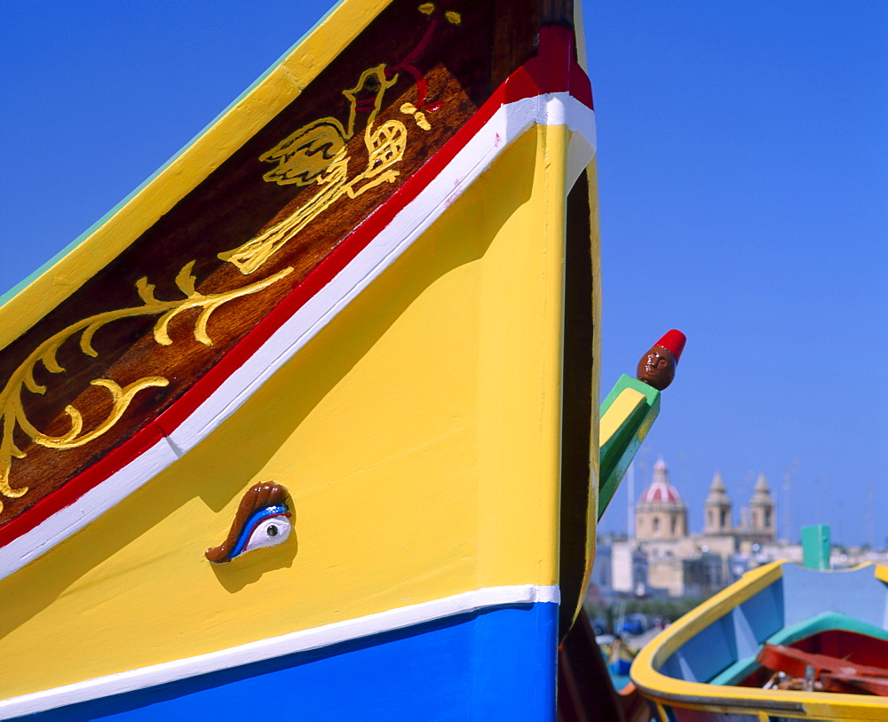 Close-up of a painted fishing boat with eye motif in the harbour at Marsaxlokk, Malta 