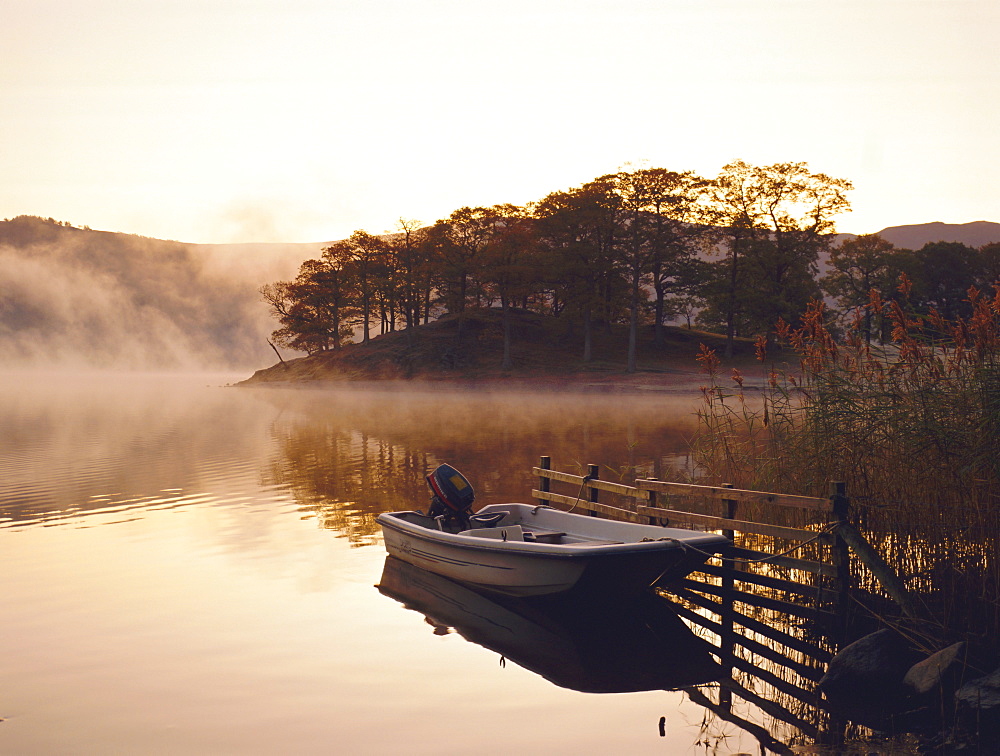 Early morning mist and boat, Derwent Water, Lake District, Cumbria, England