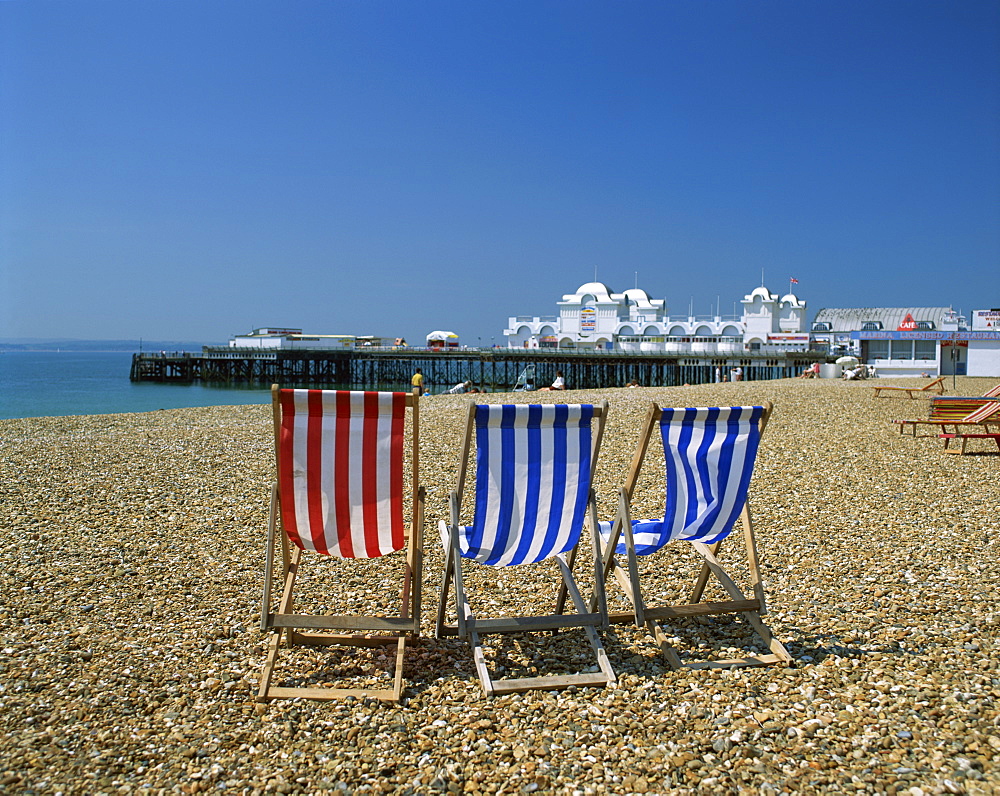 Empty deck chairs on the beach and the Southsea Pier, Southsea, Hampshire, England, United Kingdom, Europe