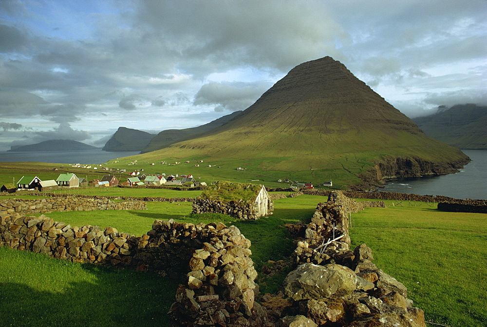 Landscape containing dry stone walls and a small settlement, Faroe Islands, Denmark, Europe