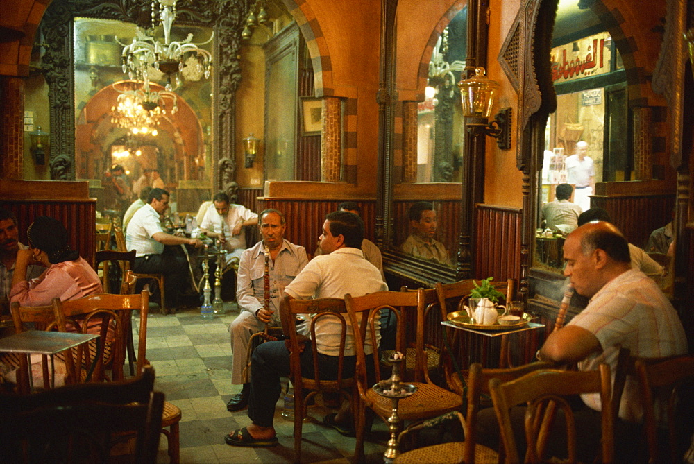 Men smoking hookahs in the interior of the El Fishawy Coffee House in Khan al-Kalili Bazaar in Cairo, Egypt, North Africa, Africa