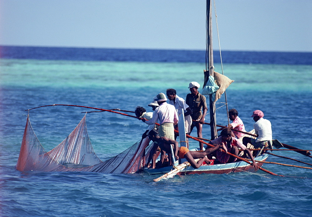 Crowded fishing boat raising its nets, Maldives, Indian Ocean, Asia