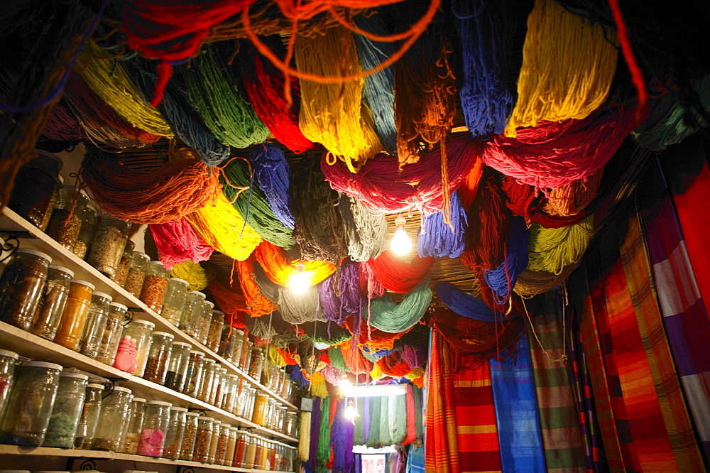 Brightly dyed wool hanging from roof of a shop, Marrakech, Morocco, North Africa, Africa 