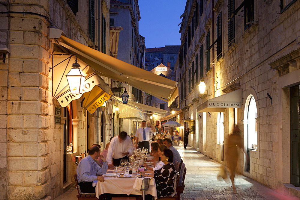 People eating at outdoor restaurant at dusk in the old town, Dubrovnik, Croatia, Europe