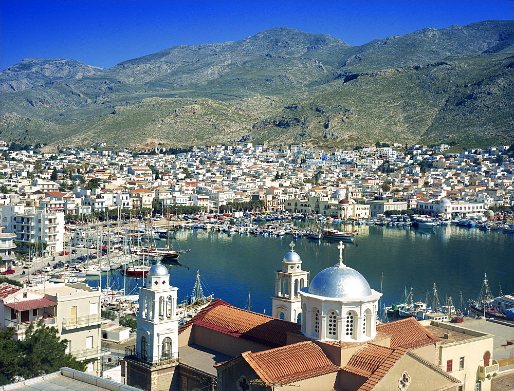 Silver domes of church with the port and town of Kalimnos behind, with hills in the background, Kalimnos, Dodecanese Islands, Greek Islands, Greece, Europe