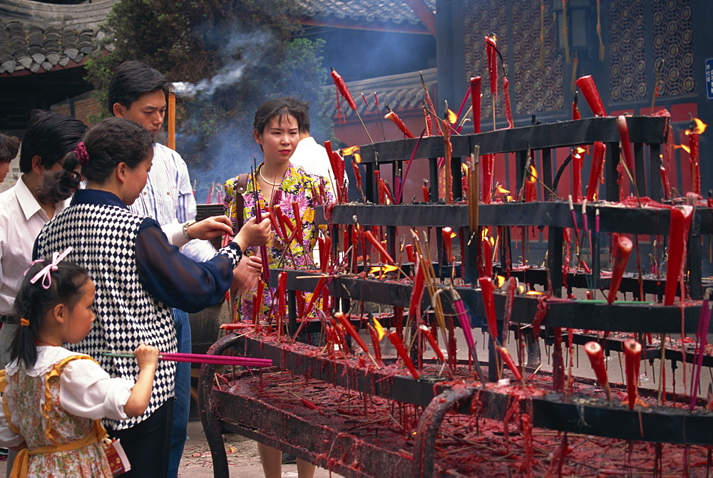 People lighting candles in the Wenshu Temple in Chengdu, Sichuan, China, Asia