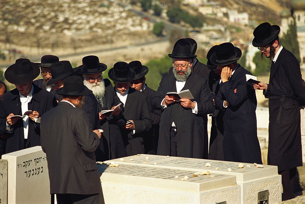 Orthodox Jews praying on a tomb on the Mount of Olives, in Jerusalem, Israel, Middle East