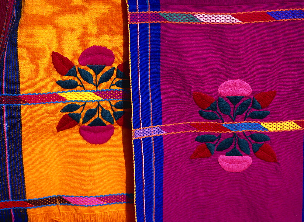 Brightly coloured craft rugs on display at San Cristobal de las Casas, in Chiapas, Mexico, North America