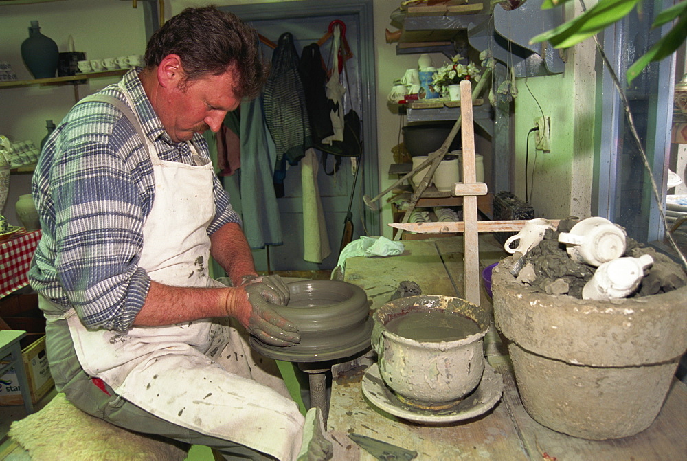 Man working on potter's wheel, ceramics workshop, Corund, Transylvania, Romania, Europe