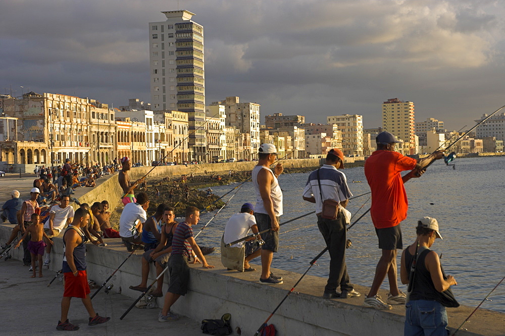 Men fishing at sunset, Avenue Maceo, El Malecon, Havana, Cuba, West Indies, Central America