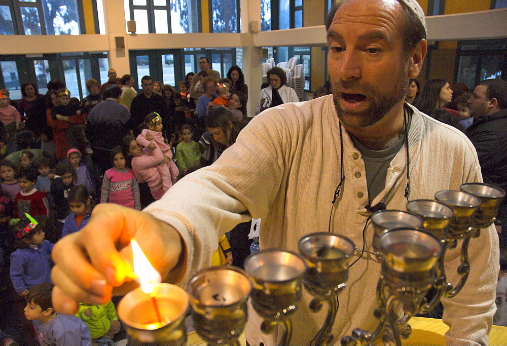 Man lighting first candle for the Hanukkah festival, while saying the benediction, Kol Haneshamah conservative Jewish community, Jerusalem, Israel, Middle East