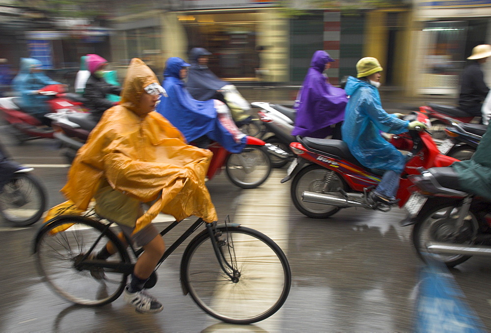 People riding bikes and mopeds in the rain wearing nylon protection, Old Quarter, Hanoi, Vietnam, Indochina, Southeast Asia, Asia