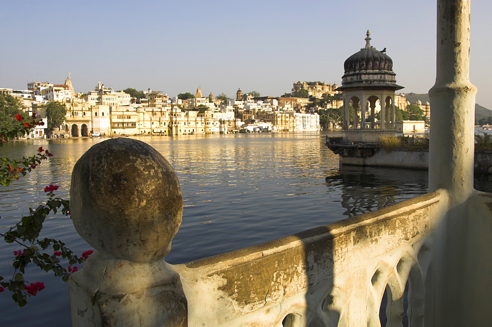 View of old city across Pichola Lake, and decorative lookout tower, Udapiur, Rajasthan state, India, Asia