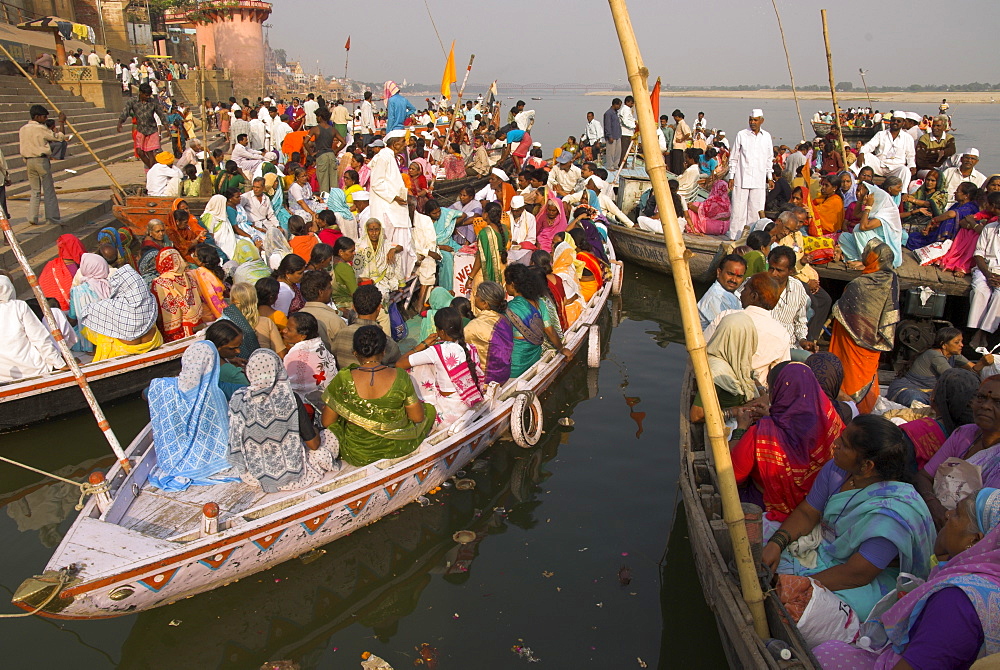 Groups of pilgrims in small boats on their way to a religious ceremony on the River Ganges, Varanasi, Uttar Pradesh state, India, Asia