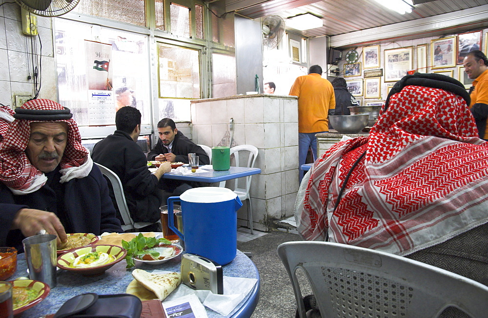 Men in keffiyeh eating traditional humus in Hashem restaurant, downtown area, Amman, Jordan, Middle East