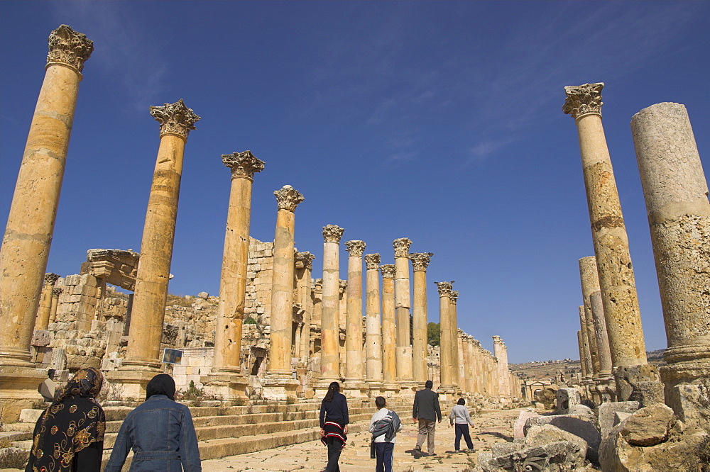 Family walking up Cardo Maximus, Jerash, Jordan, Middle East