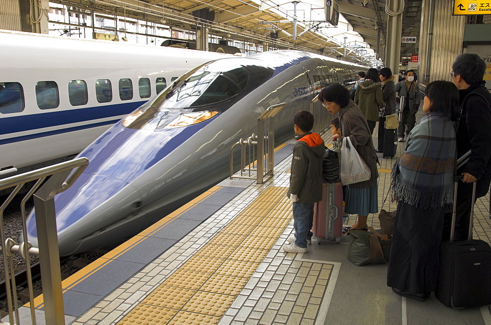 People waiting on platform with trains arriving, Kyoto Shinkansen station, Kansai, Honshu, Japan, Asia