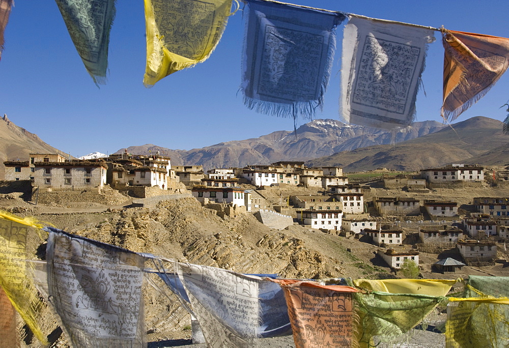 View of the village of Kibber, 4205 m, through traditional prayer flags, Spiti, Himachal Pradesh, India, Asia