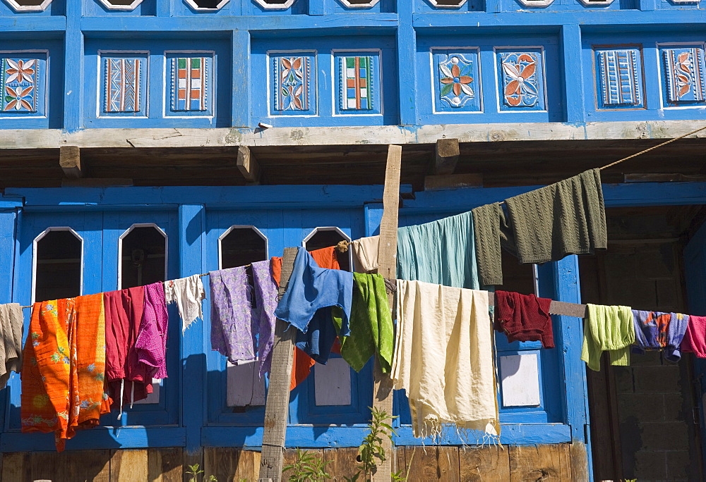 Close up of colourful laundry hanging in front of blue traditional house, village of Kalpa, Recong Peo, Kinnaur, Himachal Pradesh, India, Asia