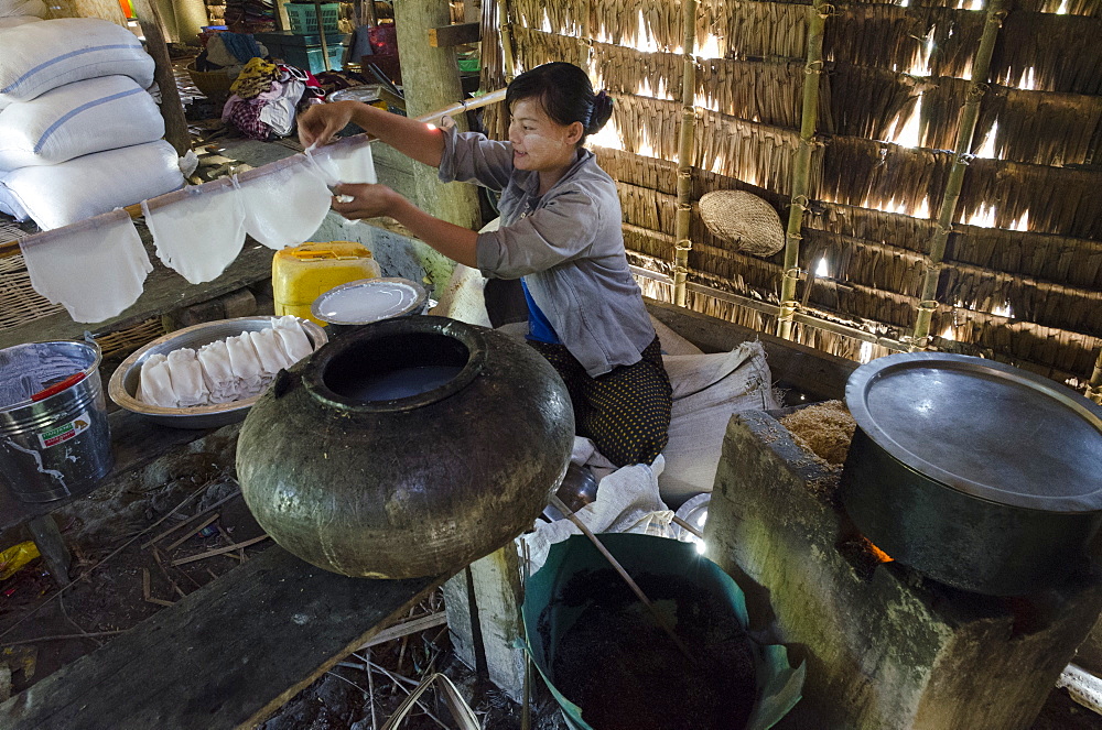 Young woman peparing rice noodles at home, Yae Saing Kone village, Irrawaddy Delta, Myanmar (Burma), Asia