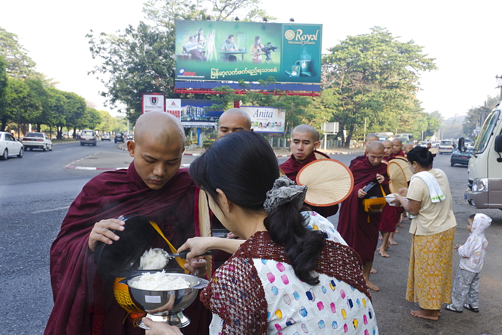 Monks gathering alms in the streets of Yangon, Myanmar (Burma), Asia